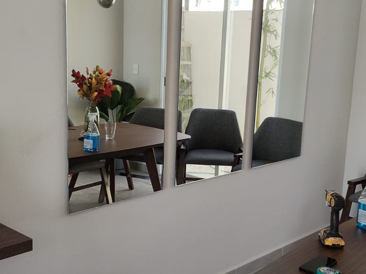 Three-panel mirror on a dining room wall