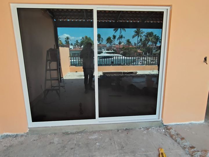 White aluminum sliding door with tinted glass overlooking the marina