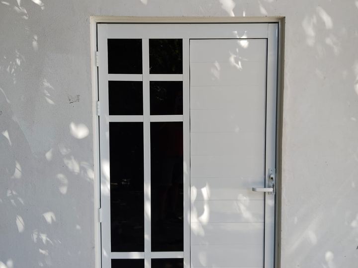 White aluminum grid-glazed door seen from inside