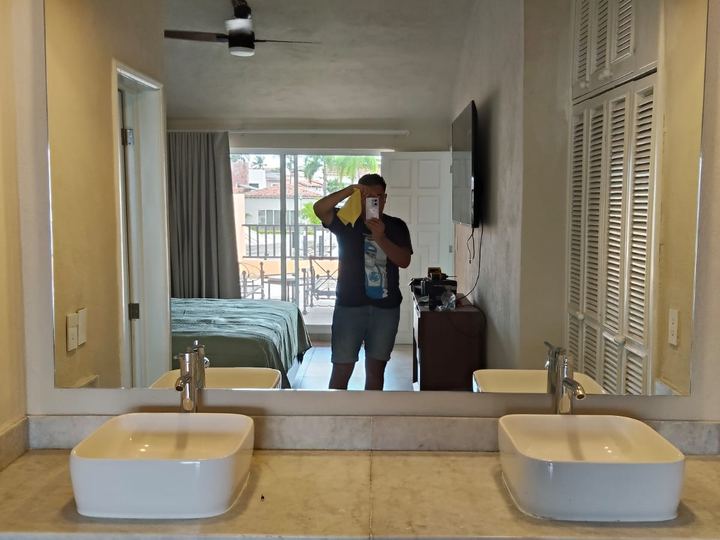Custom mirror above a marble countertop with a double vanity