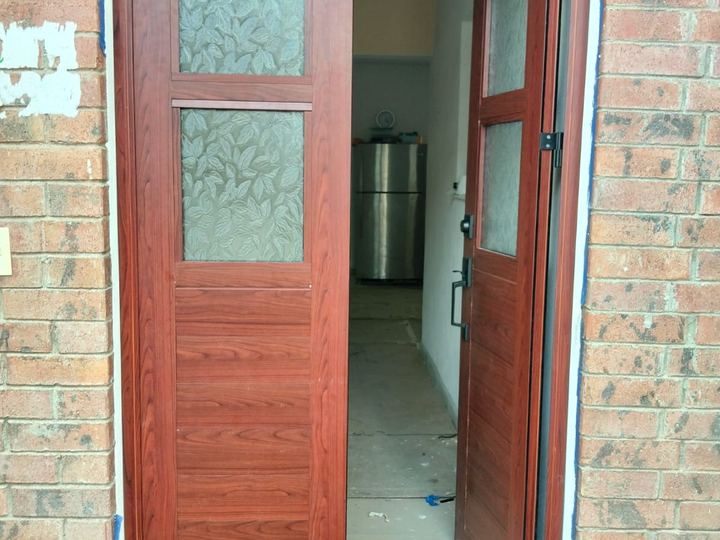 Wood-finish aluminum entry door with decorative glass