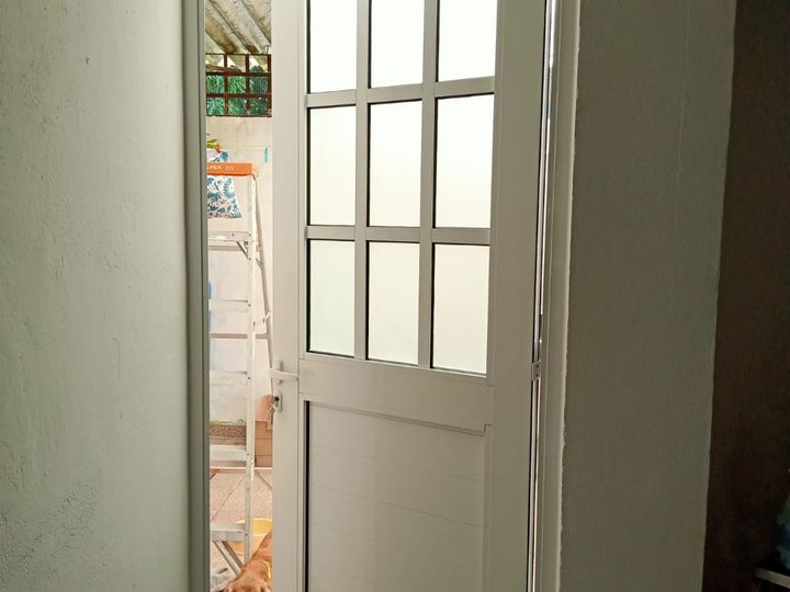 White aluminum door with frosted glass opening onto the patio