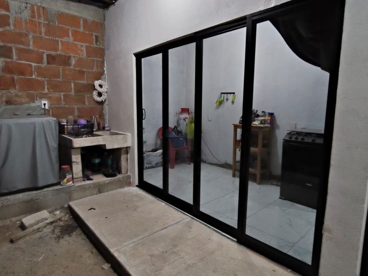 Four-panel black aluminum sliding enclosure in a kitchen