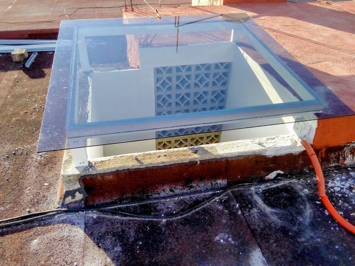 Tempered glass skylight over a rooftop opening