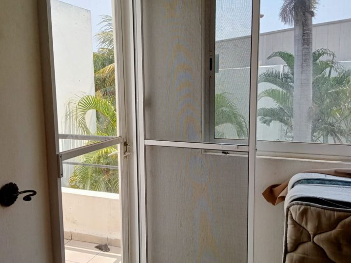 White aluminum hinged insect screen on a balcony door