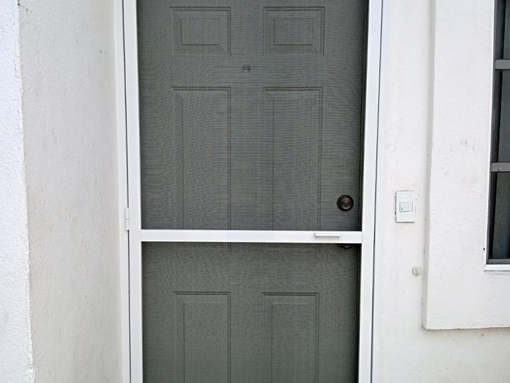 Hinged insect screen over a panelled door